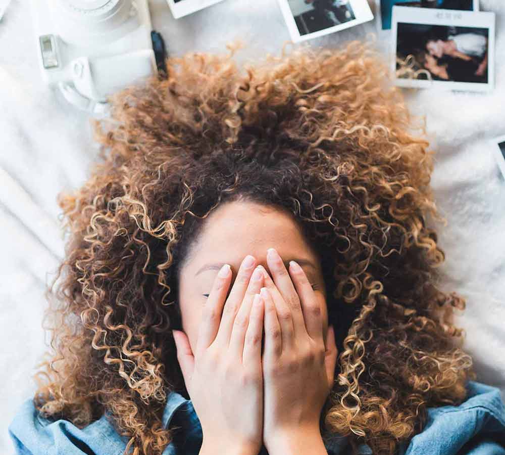 Girl Holding Her Hands Over Her Face